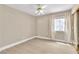 Neutral bedroom with a ceiling fan, window with curtains, and a mirrored closet at 2617 Huber Heights Dr, Las Vegas, NV 89128