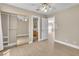 Bedroom featuring a ceiling fan, light wood floors, and a view into the bathroom at 2617 Huber Heights Dr, Las Vegas, NV 89128