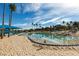 Picturesque community beach and lagoon with beach umbrellas and palm trees on a sunny day at 2617 Huber Heights Dr, Las Vegas, NV 89128