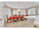 Formal dining room with elegant chandelier, decorative chairs, and large windows at 2617 Huber Heights Dr, Las Vegas, NV 89128