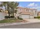 Elegant two-story home with a three-car garage, tile roof, and meticulously manicured lawn at 2617 Huber Heights Dr, Las Vegas, NV 89128