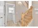 Hallway featuring stairs with wood handrails, a nearby doorway, and neutral wall color at 2617 Huber Heights Dr, Las Vegas, NV 89128