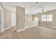 Open living area featuring wood-like floors, a ceiling fan, and ample natural light at 2617 Huber Heights Dr, Las Vegas, NV 89128