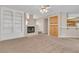 Living room with a fireplace, built-in shelving, and carpet at 2617 Huber Heights Dr, Las Vegas, NV 89128