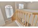 View of a wooden staircase with a light-colored wood railing and a window at the top of the stairs at 2617 Huber Heights Dr, Las Vegas, NV 89128