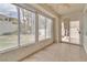 Enclosed sunroom with tile floors features large windows offering backyard views and natural light at 2617 Huber Heights Dr, Las Vegas, NV 89128