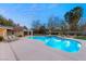 Stunning kidney-shaped pool with illuminated water and lounge chairs at 3105 Conners Dr, Las Vegas, NV 89107