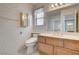 Bathroom with wood vanity, updated toilet, and floral wallpaper at 321 Carrington St, Henderson, NV 89074