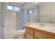 Bathroom with shower/tub combo, vanity, and window at 321 Carrington St, Henderson, NV 89074