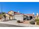 Two-story house with Spanish tile roof, attached two-car garage, and desert landscaping at 321 Carrington St, Henderson, NV 89074