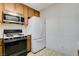 Kitchen features wood cabinets, microwave, and refrigerator at 321 Carrington St, Henderson, NV 89074