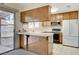 Kitchen features wood cabinets, a breakfast bar, and white appliances at 321 Carrington St, Henderson, NV 89074