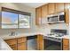 Kitchen features wood cabinets and stainless steel appliances at 321 Carrington St, Henderson, NV 89074