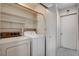 Bright laundry room with washer, dryer, and shelving at 321 Carrington St, Henderson, NV 89074