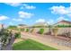 Landscaped backyard with a stone pathway, green grass, and a block wall at 3236 Mystic Ridge Ct, Las Vegas, NV 89129