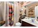 Bathroom with unique shower curtain and dark vanity at 3327 Outlook Point St, North Las Vegas, NV 89032