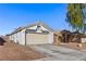 One-story house with light-colored exterior, two-car garage, and desert landscaping at 3327 Outlook Point St, North Las Vegas, NV 89032