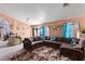 Spacious living room featuring a large sectional sofa and decorative wall accents at 3327 Outlook Point St, North Las Vegas, NV 89032