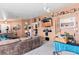 Living room with sectional sofa, flat-screen TV, and eclectic decor at 3327 Outlook Point St, North Las Vegas, NV 89032