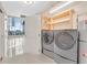 Convenient laundry room with washer, dryer, and shelving at 360 E Desert Inn Rd # 1201, Las Vegas, NV 89109