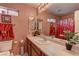 Clean bathroom with a single sink, shower, and red accents at 3728 Spiritual Way, Las Vegas, NV 89115