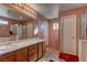 Bathroom with double vanity and wood cabinets at 3728 Spiritual Way, Las Vegas, NV 89115