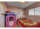 bedroom with floral bedding, playhouse, and white headboard at 3728 Spiritual Way, Las Vegas, NV 89115