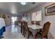 Dining area with wooden table and chairs, and access to the back yard at 3728 Spiritual Way, Las Vegas, NV 89115