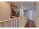 Upstairs hallway with hardwood floors and white railings at 3728 Spiritual Way, Las Vegas, NV 89115