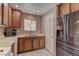 Kitchen with wood cabinets, white appliances, and tile flooring at 3728 Spiritual Way, Las Vegas, NV 89115