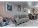 Living room features beige couch, dining table, and tiled floor at 3728 Spiritual Way, Las Vegas, NV 89115