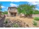 Landscaped backyard with gravel and a mature tree at 3792 Nerine Pass Way Ave, North Las Vegas, NV 89031