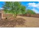 Large backyard with gravel, a tree, and desert landscaping at 3792 Nerine Pass Way Ave, North Las Vegas, NV 89031