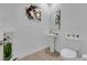 Clean and modern powder room with pedestal sink and white toilet at 3792 Nerine Pass Way Ave, North Las Vegas, NV 89031