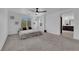 Spacious main bedroom with ceiling fan, large window, and grey carpet at 3792 Nerine Pass Way Ave, North Las Vegas, NV 89031