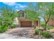 Two-story house with brown garage door and landscaped front yard at 3792 Nerine Pass Way Ave, North Las Vegas, NV 89031