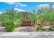 Two-story house with brown garage door and landscaped front yard at 3792 Nerine Pass Way Ave, North Las Vegas, NV 89031