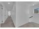 Upstairs hallway with carpet, doors to bedrooms, and staircase at 3792 Nerine Pass Way Ave, North Las Vegas, NV 89031