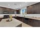 Spacious kitchen with dark brown cabinets and granite countertops at 3792 Nerine Pass Way Ave, North Las Vegas, NV 89031