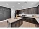 Spacious kitchen with dark cabinetry, granite island, and stainless steel appliances at 3792 Nerine Pass Way Ave, North Las Vegas, NV 89031