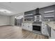 Modern kitchen with granite countertops, stainless steel appliances, and white cabinets at 3849 Boca Chica Ave, Las Vegas, NV 89120