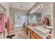 Elegant bathroom with double sinks, a large soaking tub, and plenty of storage at 3918 Champagne Wood Dr, North Las Vegas, NV 89031