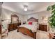 Elegant Primary bedroom with dark wood furniture and ceiling fan at 3918 Champagne Wood Dr, North Las Vegas, NV 89031