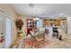 Bright dining area with wood floor, chandelier, and a table for four at 3918 Champagne Wood Dr, North Las Vegas, NV 89031