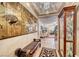 Elegant entryway, featuring a bench and display cabinet, leading to living room at 3918 Champagne Wood Dr, North Las Vegas, NV 89031