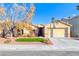 Single-story house with a landscaped front yard and two-car garage at 3918 Champagne Wood Dr, North Las Vegas, NV 89031