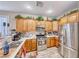 Modern kitchen with stainless steel appliances and wood cabinets at 3918 Champagne Wood Dr, North Las Vegas, NV 89031