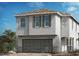 Two-story home with gray siding, gray garage door, and multiple windows at 4205 Yucca Brevi Ave, Las Vegas, NV 89139