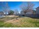 Landscaped backyard with grassy area and block wall bordering community park at 4358 Raynham St, Las Vegas, NV 89115