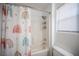 Bathroom with shower/tub, rainbow shower curtain, and window at 4358 Raynham St, Las Vegas, NV 89115